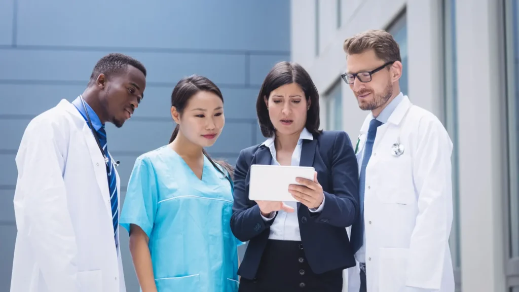 Healthcare leadership team discussing hospital strategy and executive hiring