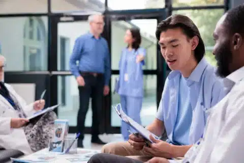 Medical director discussing healthcare leadership strategy with hospital executives