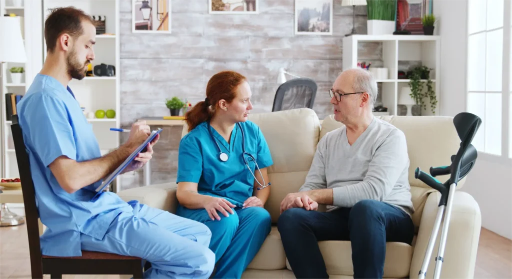 Home health nurse and hospice caregiver providing patient care in a home setting